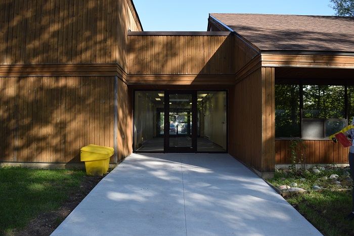 A wood sided building with slanted roofs.