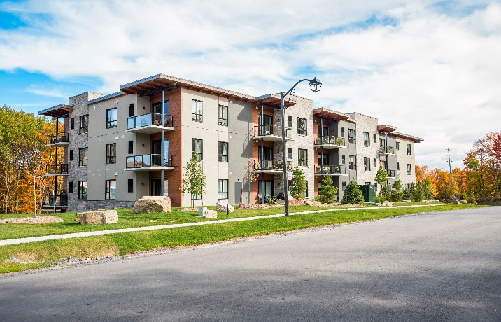 grey condo apartment building with wood accents